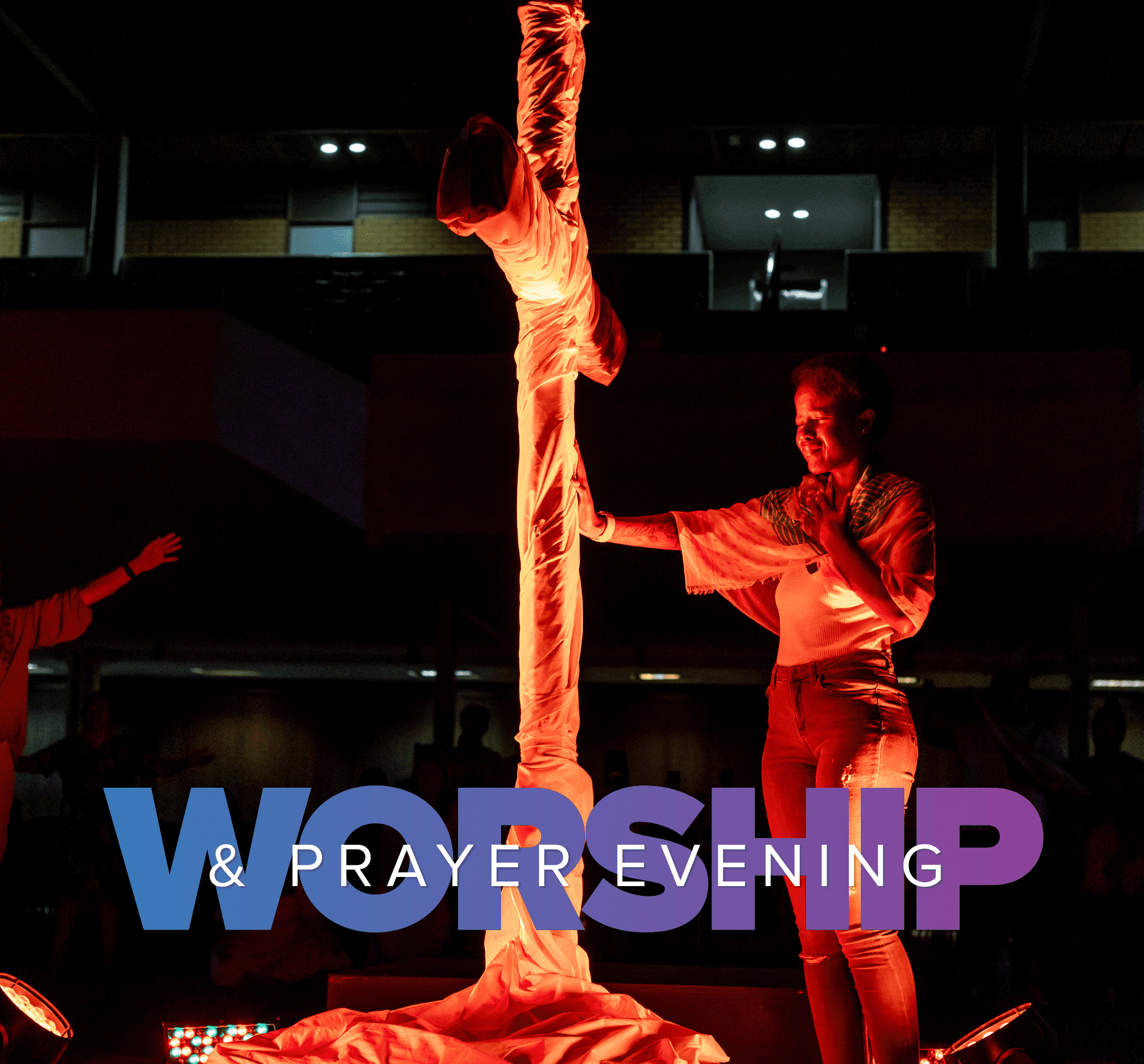 Woman standing at a mock cross worshipping.